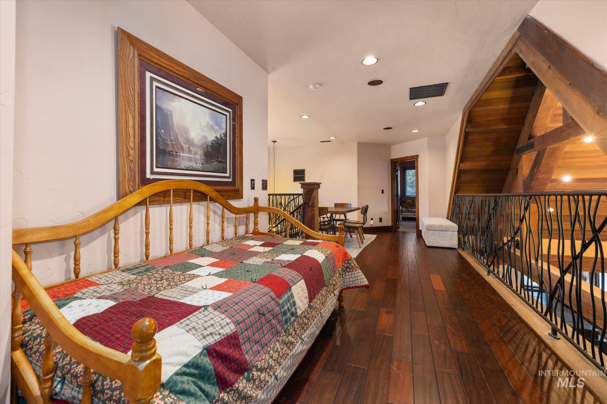 14 Pointe At Goldfork Court Donnelly, ID 83615 - Photo 32 of 49 Loft space featuring rich wood-finish flooring and a wrought iron railing with organic-inspired detailing