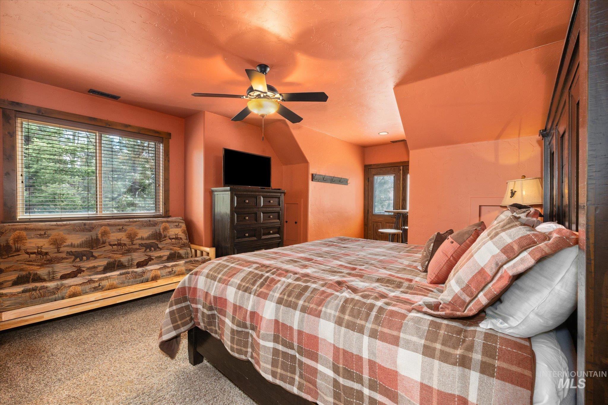 14 Pointe At Goldfork Court Donnelly, ID 83615 - Photo 33 of 49 Carpeted room featuring a ceiling fan with light fixture, a window with blinds, and a built-in wooden headboard