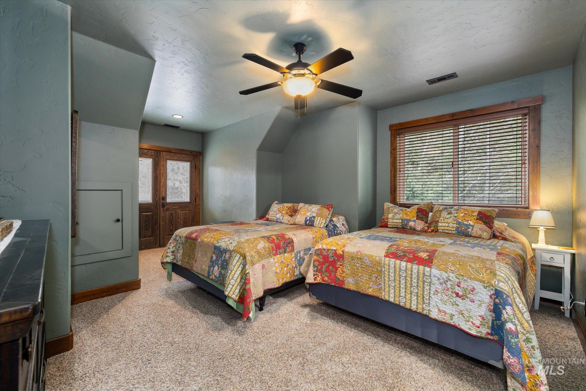 14 Pointe At Goldfork Court Donnelly, ID 83615 - Photo 35 of 49 Carpeted interior space featuring wood-finish window trim, a ceiling fan with integrated lighting, and painted walls