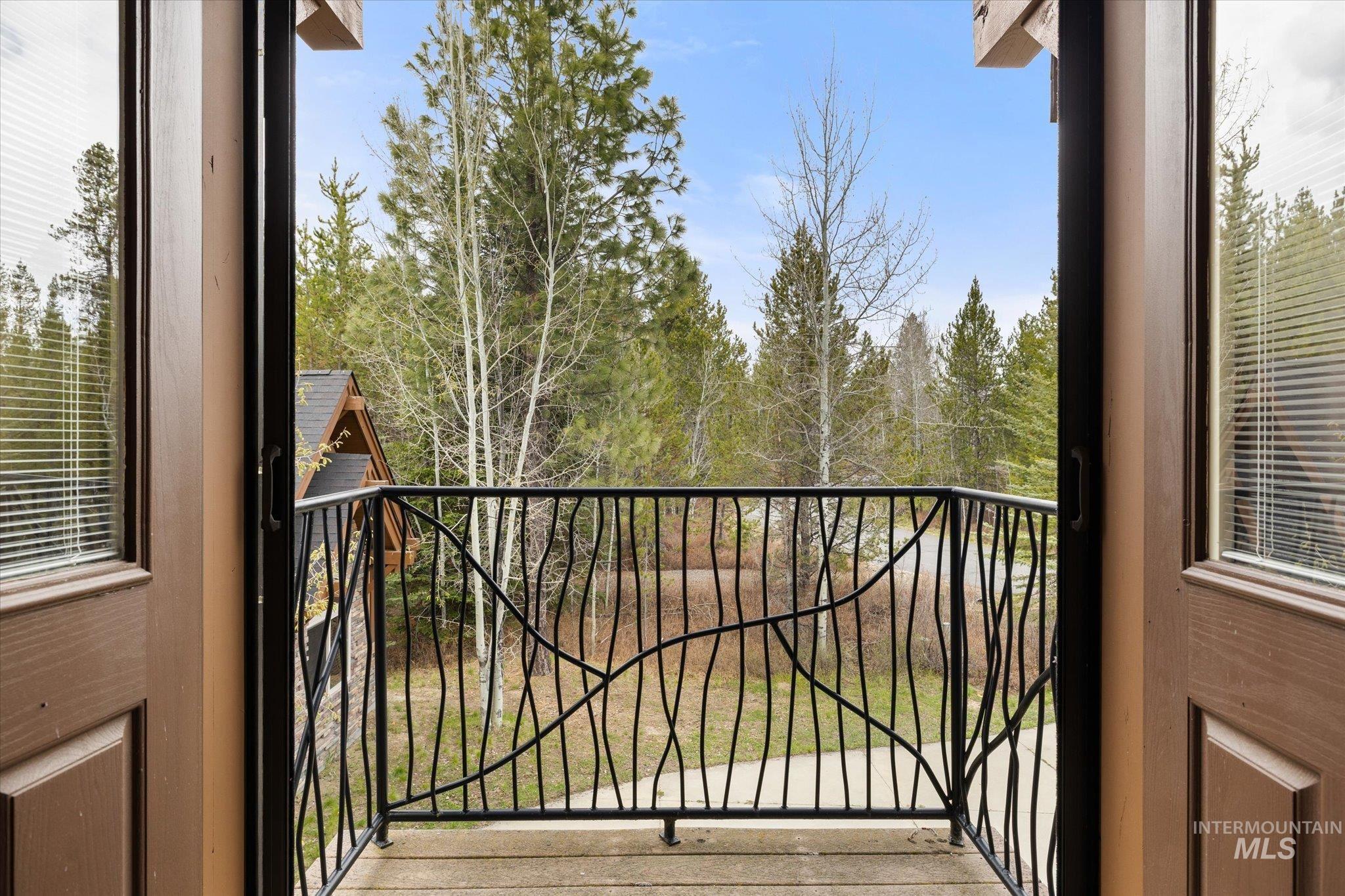 14 Pointe At Goldfork Court Donnelly, ID 83615 - Photo 36 of 49 Private balcony with decorative wrought iron railing, wood-finish flooring, and natural wooded surroundings