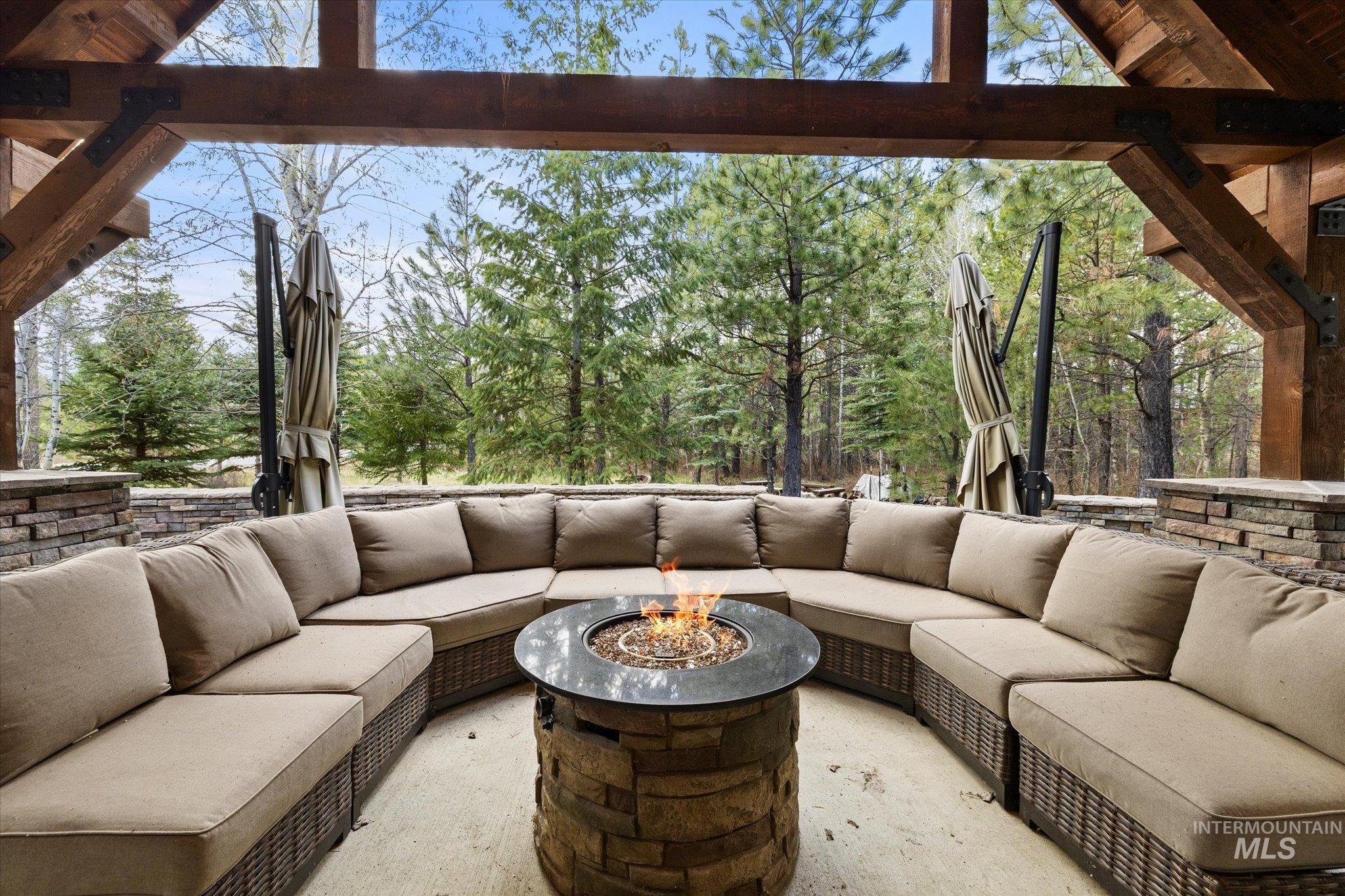 14 Pointe At Goldfork Court Donnelly, ID 83615 - Photo 38 of 49 Covered outdoor patio featuring a stone-clad fire pit