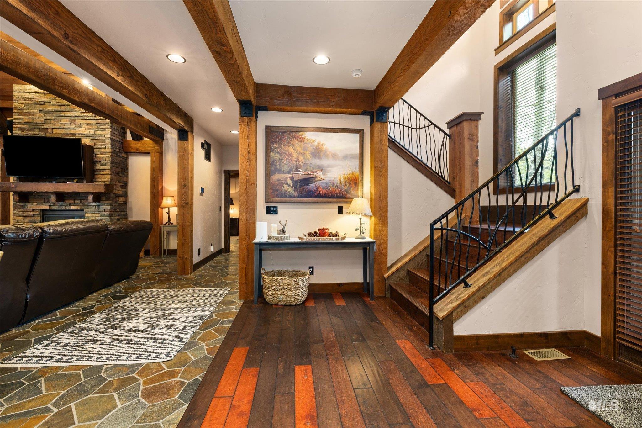 14 Pointe At Goldfork Court Donnelly, ID 83615 - Photo 4 of 49 Entryway featuring wood-finish flooring with accent planks and a staircase with decorative wrought iron railing