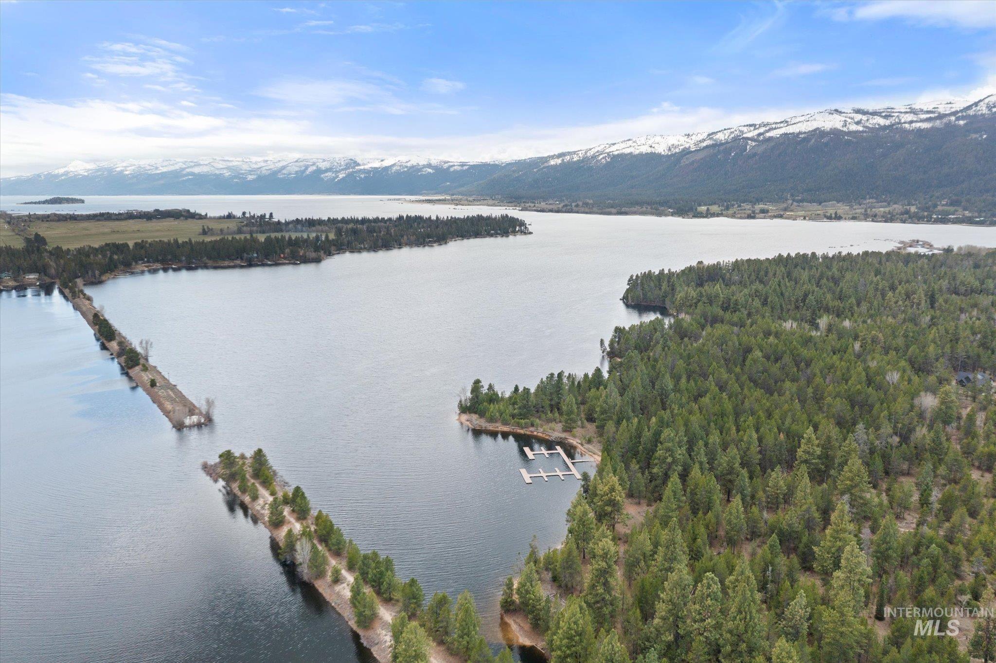 14 Pointe At Goldfork Court Donnelly, ID 83615 - Photo 47 of 49 Expansive lakefront property featuring a private dock system, surrounding dense evergreen forest, and distant snow-capped mountains