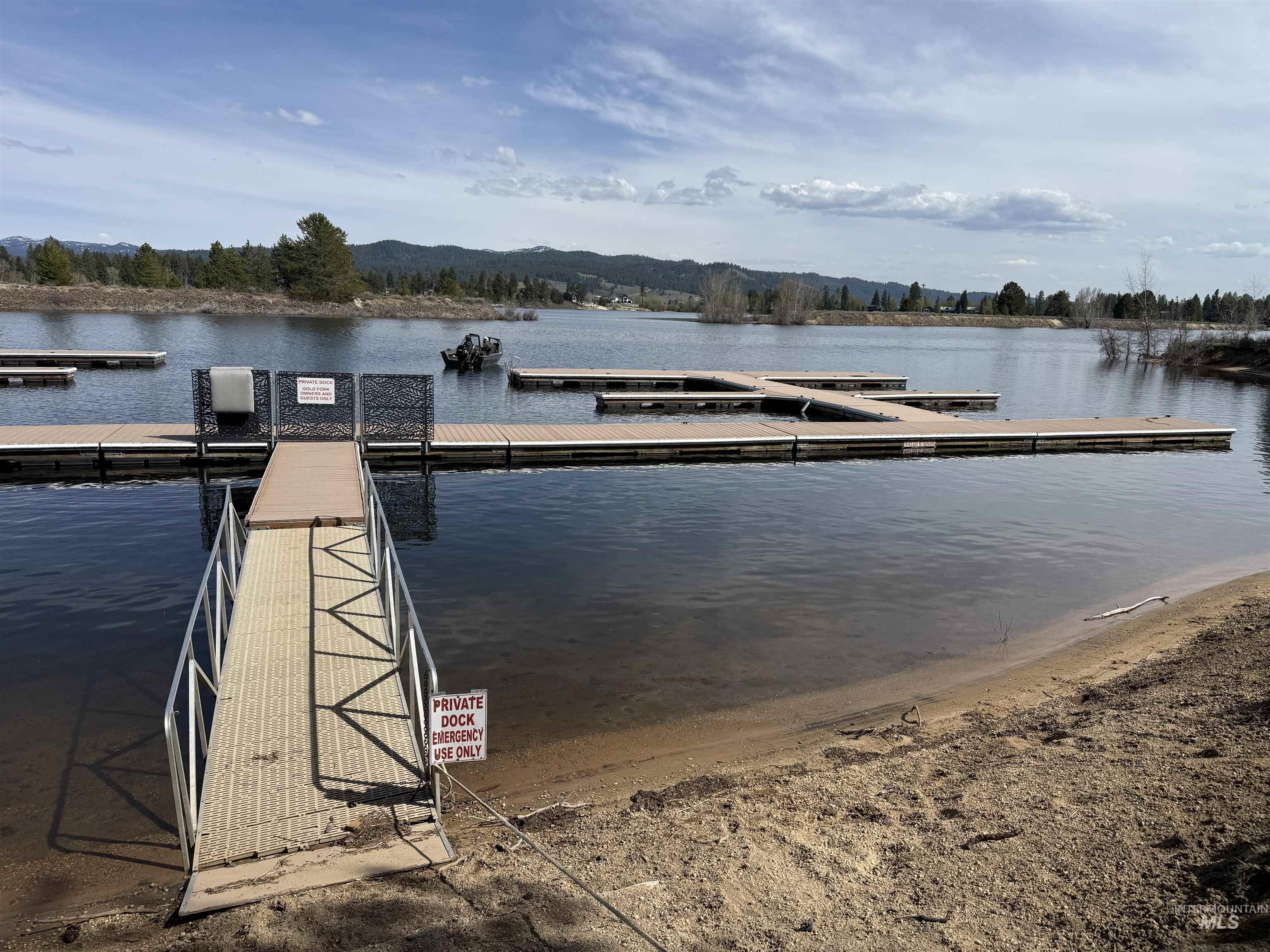 14 Pointe At Goldfork Court Donnelly, ID 83615 - Photo 48 of 49 Private dock access featuring a metal ramp, multiple floating dock sections, and a sandy shoreline
