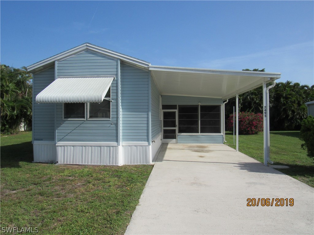 7695 Carpenter Road Bokeelia, FL 33922 - Photo 1 of 26 a front view of a house with a large window