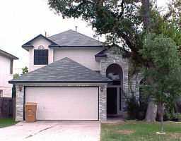 a front view of a house with a garden and plants