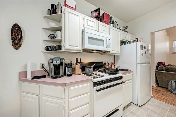 a kitchen with refrigerator and cabinets