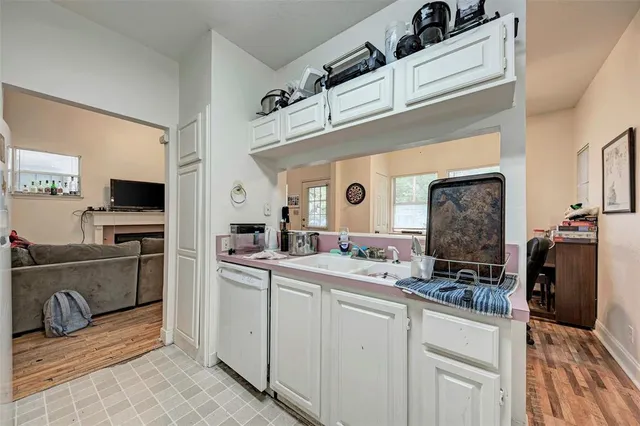 a white house covered with tall trees