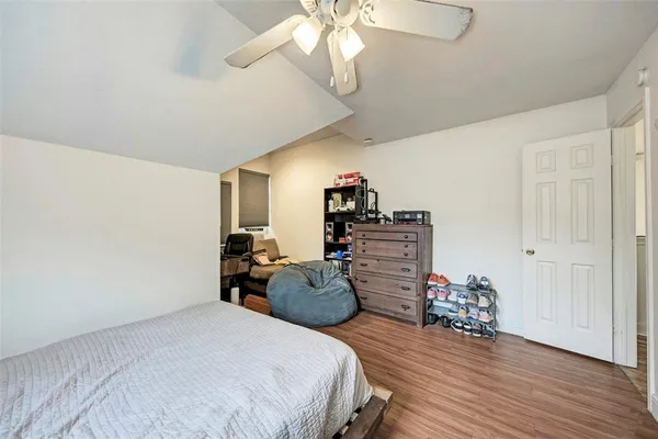 a bedroom with a bed window and a flat screen tv