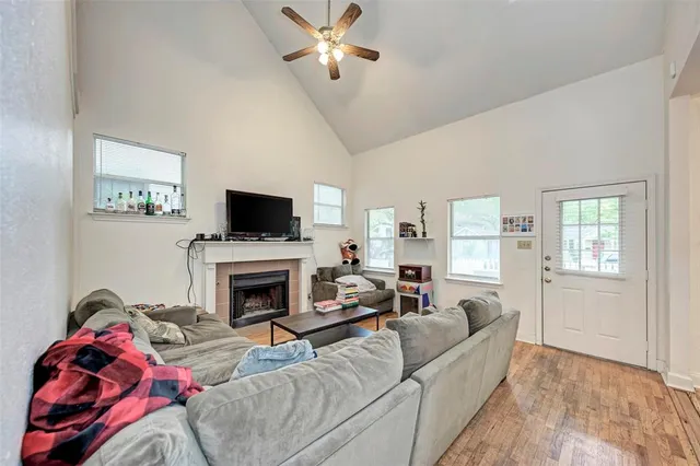 a living room with furniture a flat screen tv and a fireplace