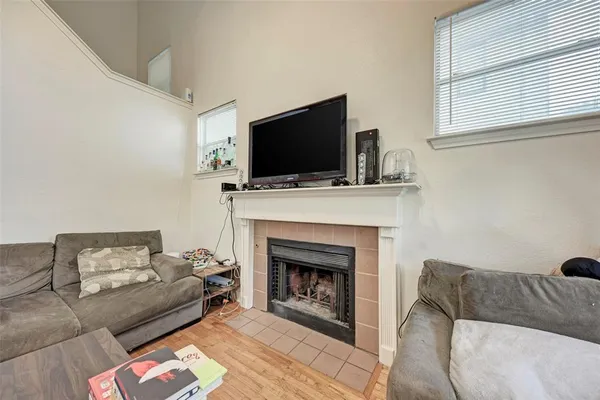 a living room with furniture a flat screen tv and a fireplace
