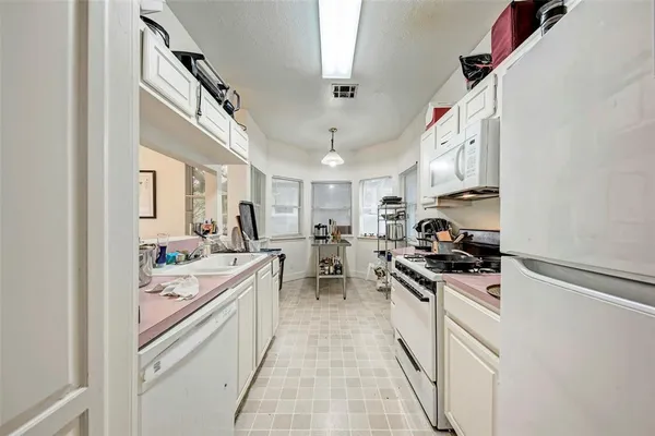 a kitchen with a sink stove and cabinets
