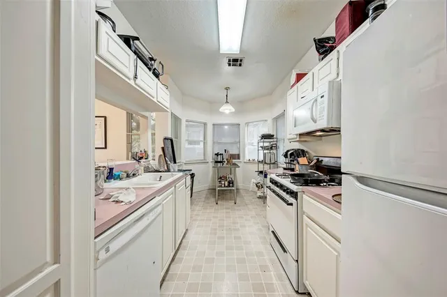 a kitchen with a sink stove and cabinets