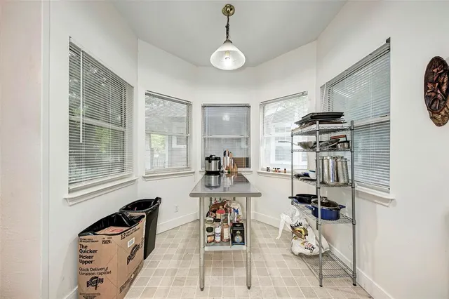 a view of a workspace with furniture and a window