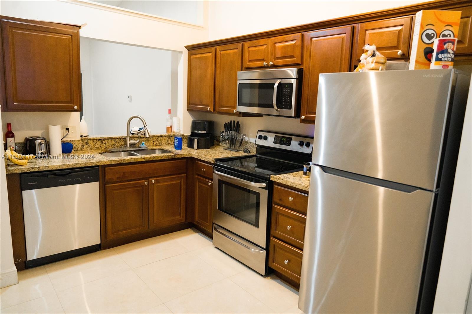 a kitchen with stainless steel appliances a refrigerator stove microwave and sink