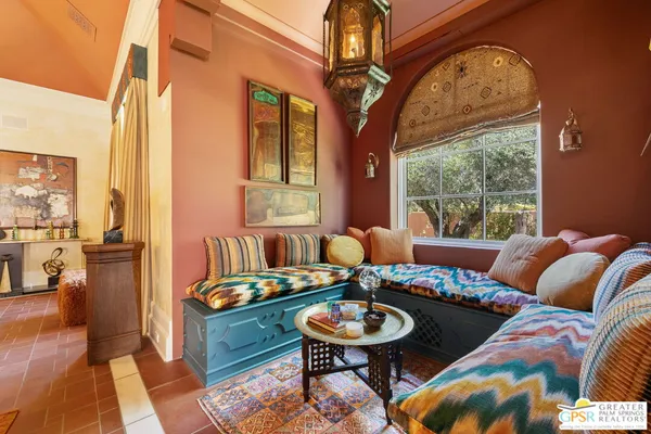 a living room with furniture a flat screen tv and large window