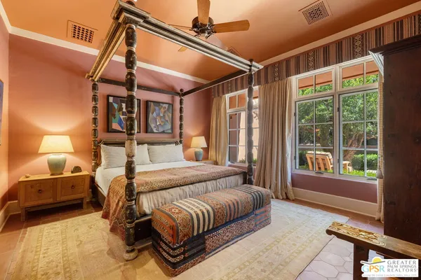 a bedroom with a large bed and a window