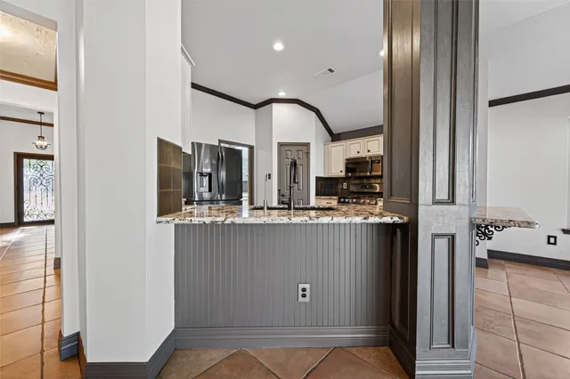 a view of an empty room with a fireplace and a window