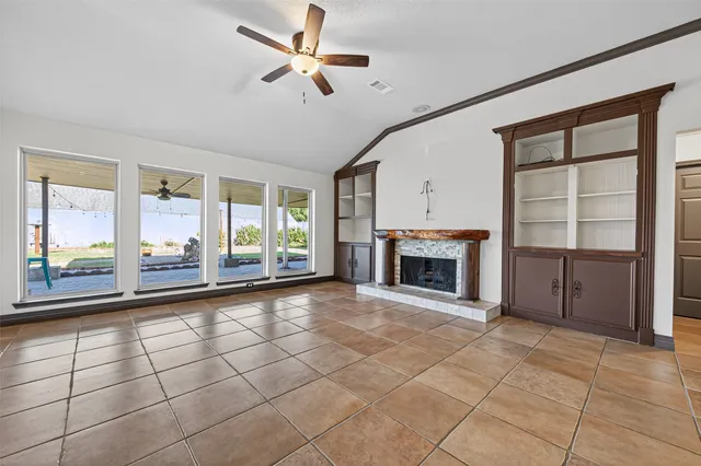 a view of a kitchen with furniture and a refrigerator