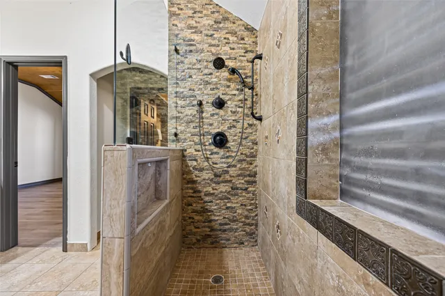 a bathroom with a granite countertop bathtub sink vanity and mirror