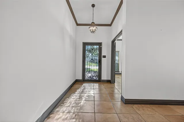 a view of a livingroom with a chandelier fan and windows