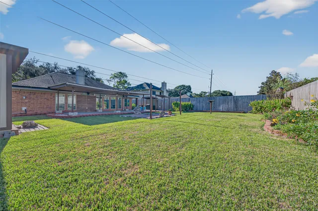 a view of a house with a big yard and potted plants