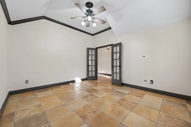 a view of a livingroom with a chandelier fan and windows