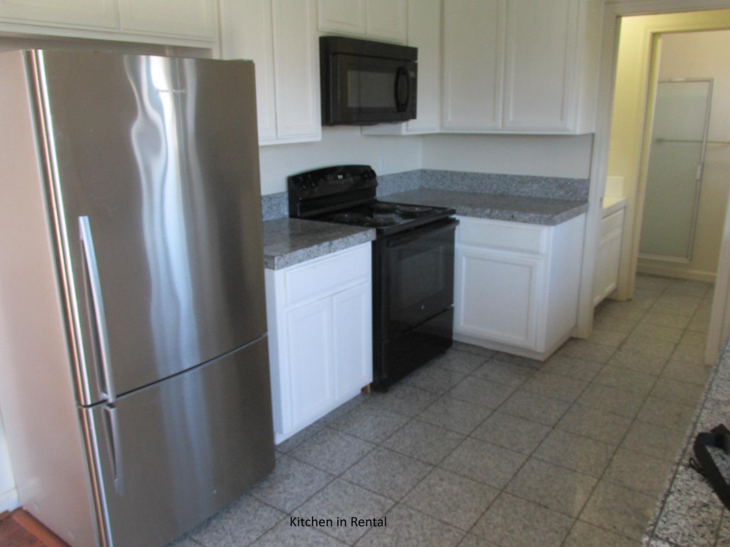 38780 Dinosaur Point Road Hollister, CA 95023 - Photo 21 of 34 a kitchen with a refrigerator stove and cabinets