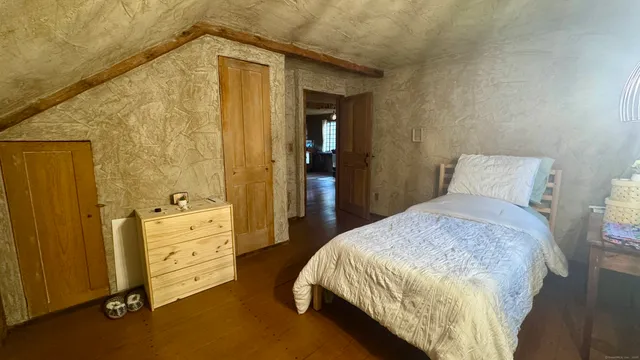 a bedroom with a bed and dresser