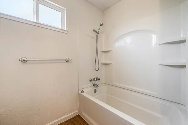 a bathroom with a tub and a shower