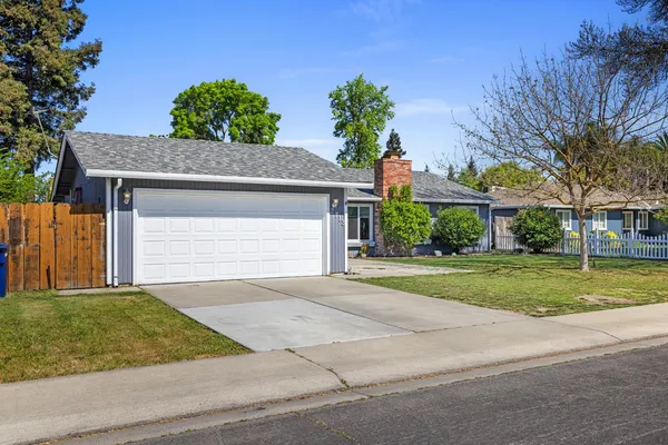 a front view of house with yard and trees
