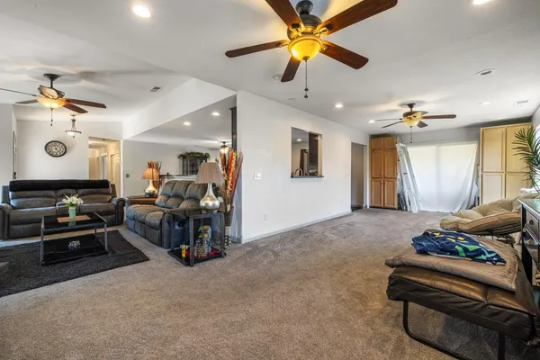 a living room with furniture and a chandelier