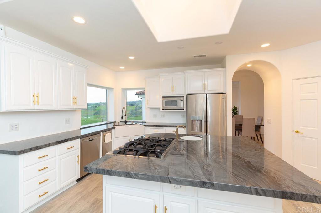 9650 Covey Lane Escondido, CA 92026 - Photo 21 of 39 a kitchen with stainless steel appliances granite countertop a sink stove and refrigerator
