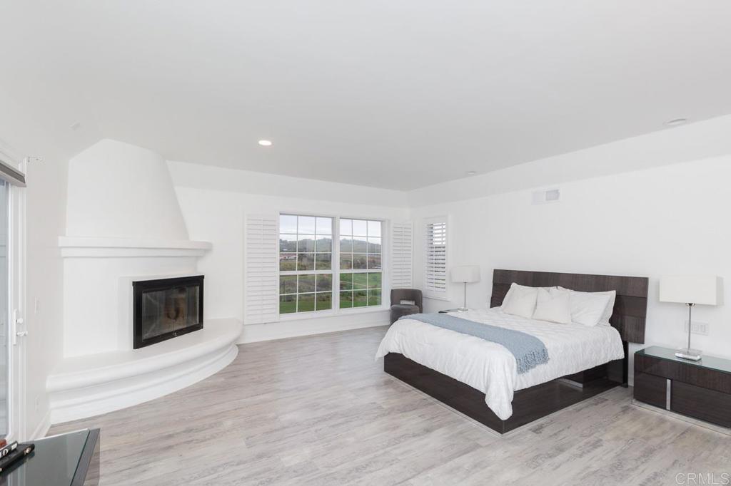 9650 Covey Lane Escondido, CA 92026 - Photo 26 of 39 a spacious bedroom with a bed and a fireplace