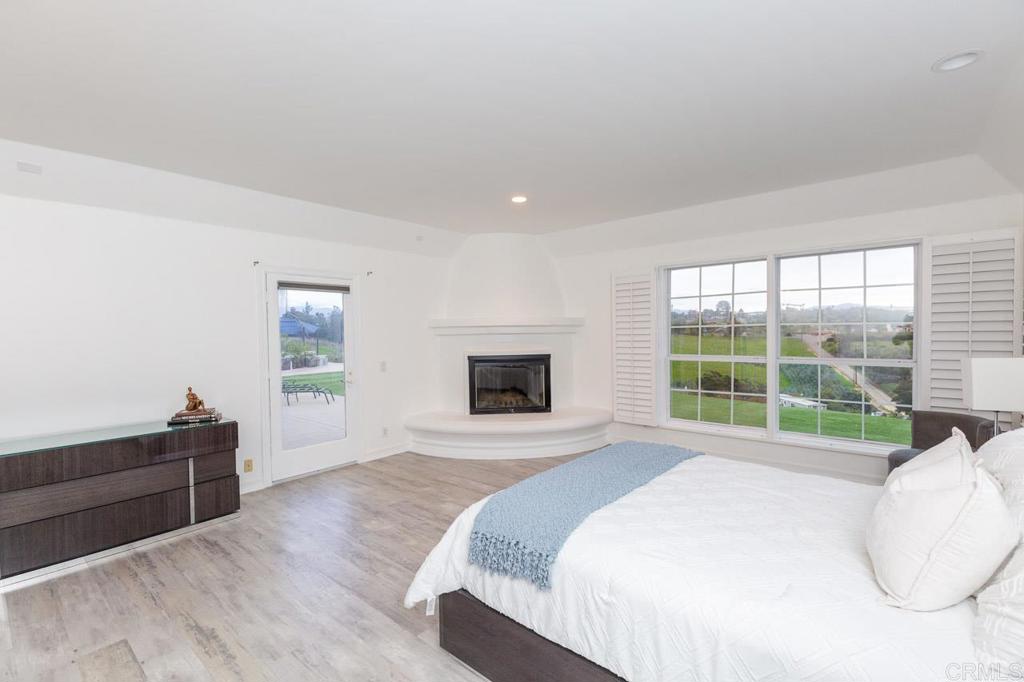 9650 Covey Lane Escondido, CA 92026 - Photo 27 of 39 a large white bed sitting in a bedroom next to a window