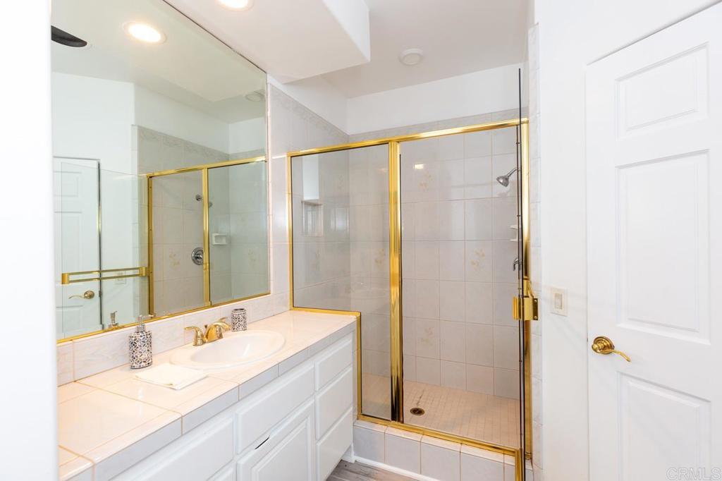 9650 Covey Lane Escondido, CA 92026 - Photo 34 of 39 a bathroom with a double vanity sink shower and a mirror