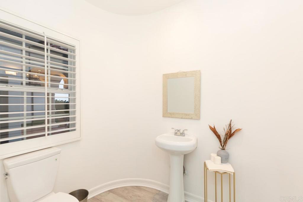9650 Covey Lane Escondido, CA 92026 - Photo 35 of 39 a bathroom with a sink toilet and a mirror