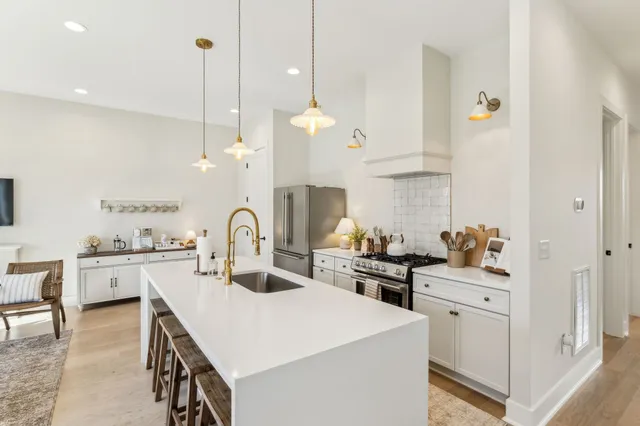 a kitchen with white cabinets and appliances