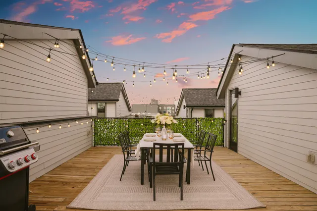 a kitchen with stainless steel appliances kitchen island granite countertop a sink a refrigerator and a stove with kitchen island