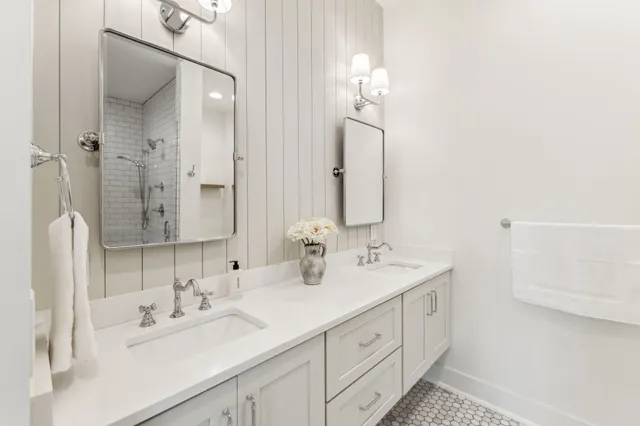 a bathroom with a granite countertop sink a toilet and mirror
