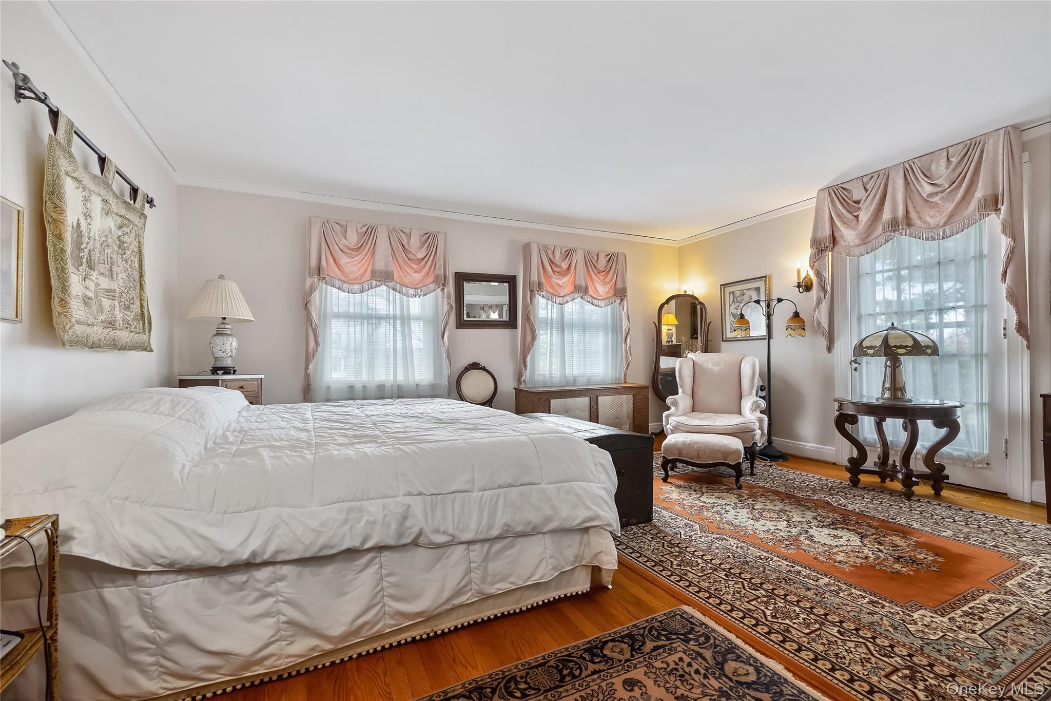 1-27 Beverly Road Queens, NY 11363 - Photo 41 of 46 a bedroom with a bed and wooden floor