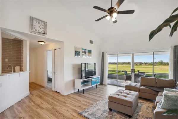 a living room with furniture and a floor to ceiling window