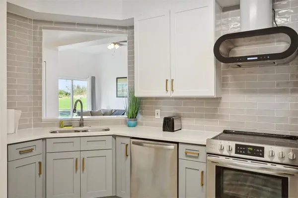 a kitchen with a sink cabinets and appliances