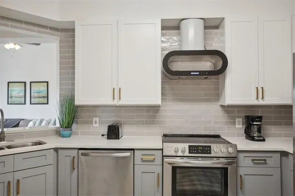 a kitchen with a sink stove and cabinets