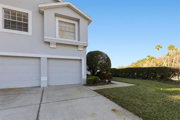 a view of a house with backyard and sitting area