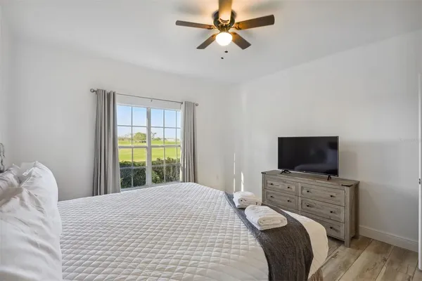 a bedroom with a bed and a flat screen tv