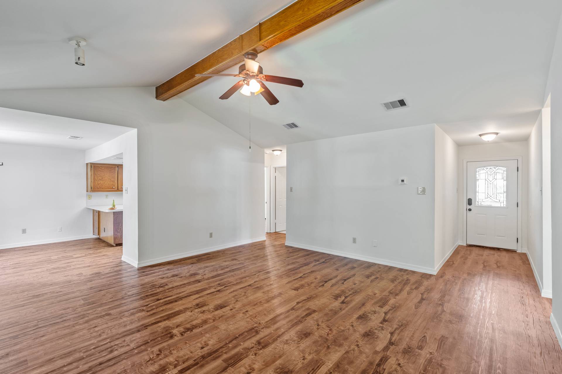 1802 Dixie Lane Round Rock, TX 78664 - Photo 16 of 30 a view of an empty room with wooden floor and a ceiling fan