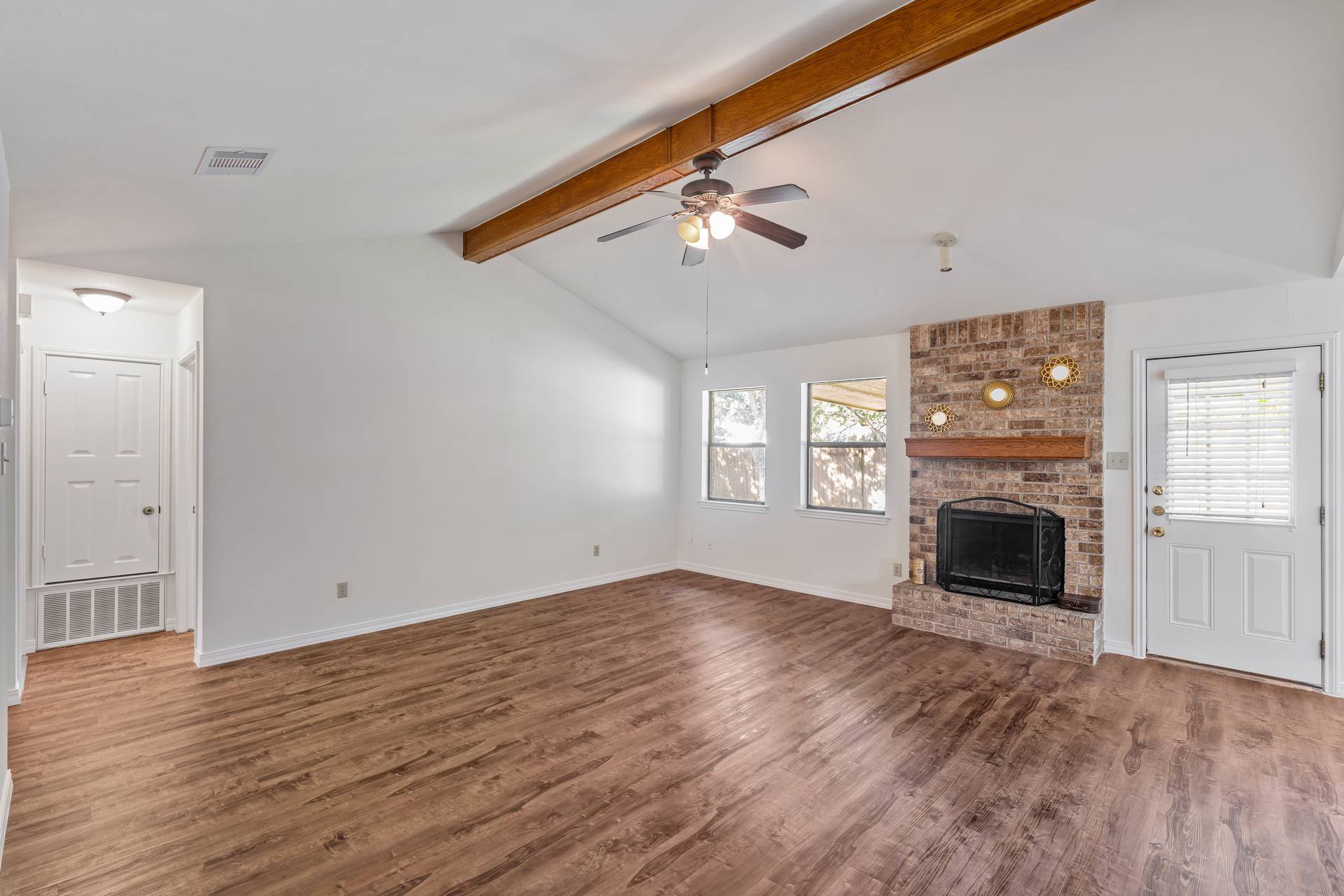 1802 Dixie Lane Round Rock, TX 78664 - Photo 18 of 30 wooden floor fireplace and windows in an empty room