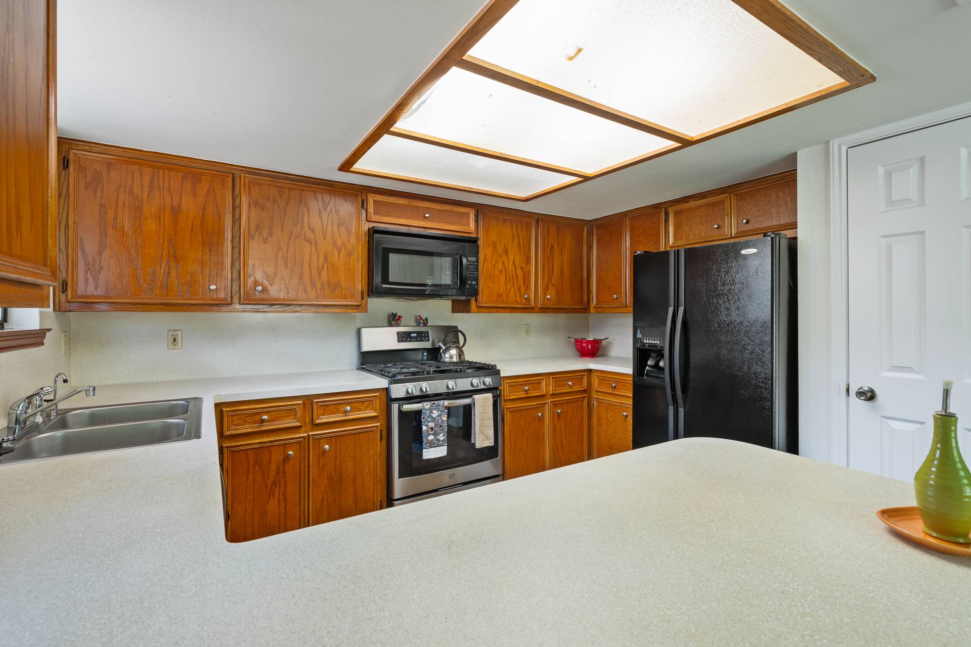 1802 Dixie Lane Round Rock, TX 78664 - Photo 28 of 30 a kitchen with stainless steel appliances granite countertop a refrigerator stove top oven a sink and dishwasher