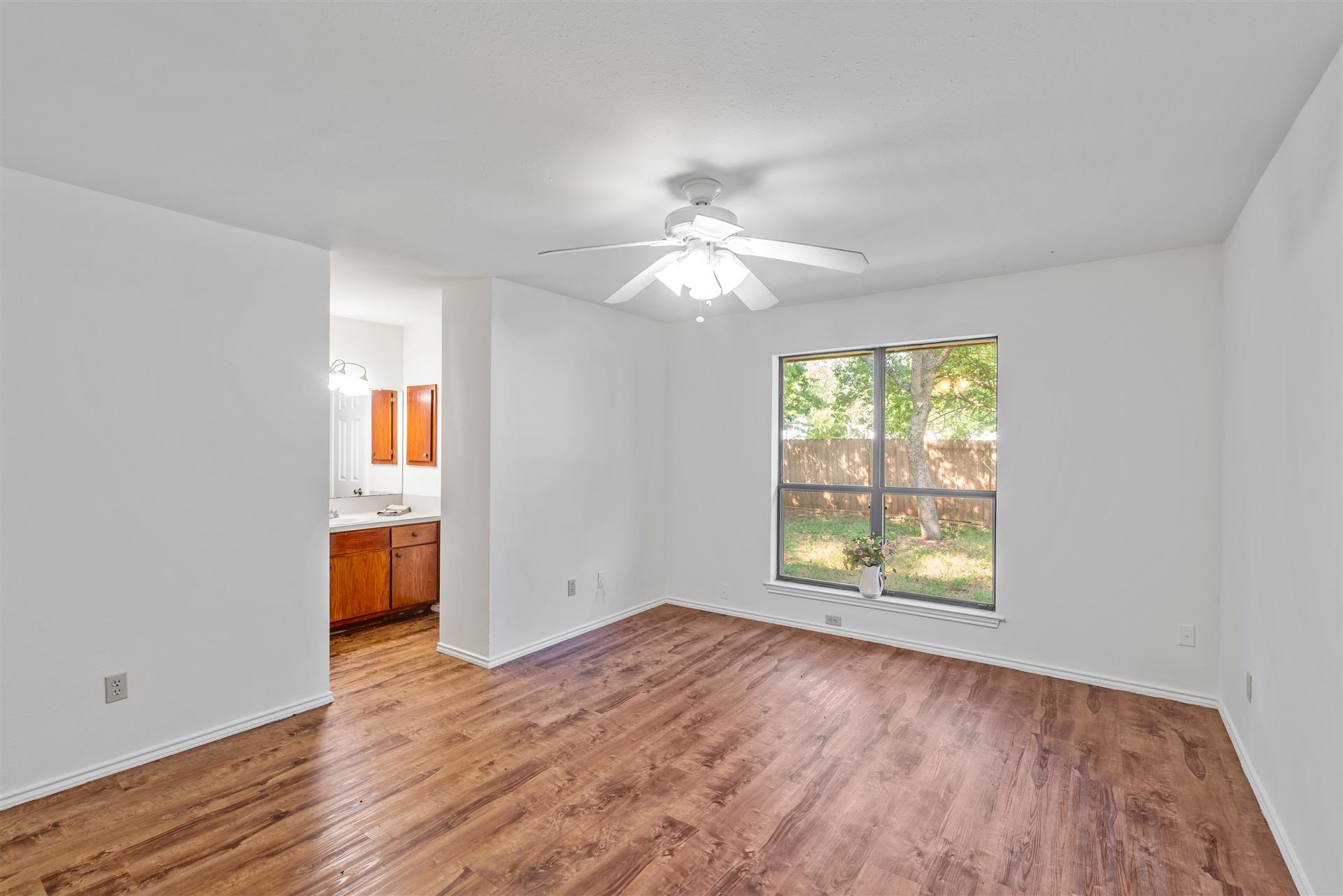 1802 Dixie Lane Round Rock, TX 78664 - Photo 3 of 30 an empty room with windows and a chandelier fan